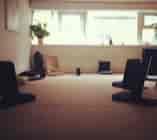 Serene workshop room with floor cushions for mindfulness sessions and retreats.