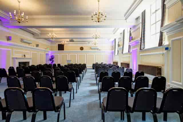 Robert Perks in Central Hall Westminster, elegant meeting space with black chairs.