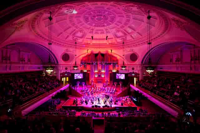 Great Hall Westminster concert with vibrant lighting and ornate architecture.