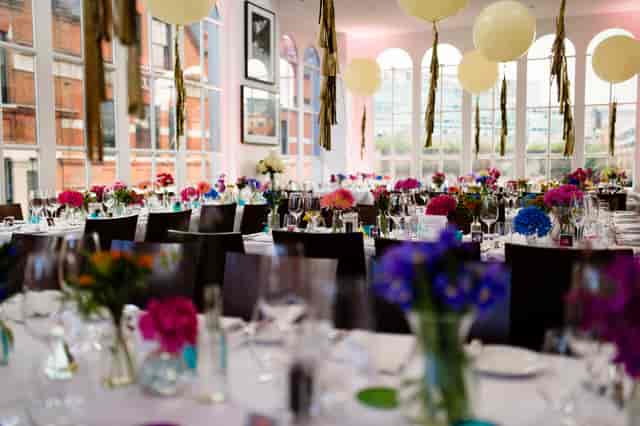 Elegant event space at Roast Restaurant with floral centerpieces for celebrations.