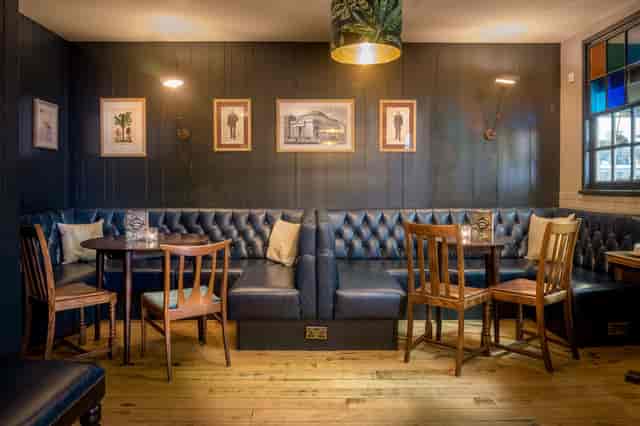 Cozy library venue with dark wood paneling for intimate meetings and small events.