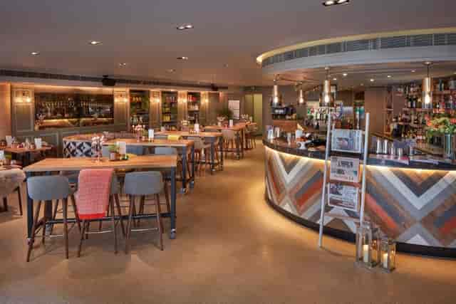 Modern event venue with stylish seating and ambient lighting for meetings.