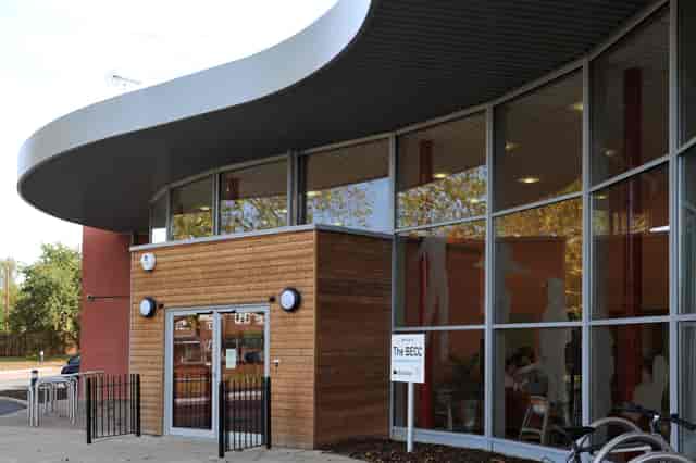 Modern reception venue with curved design and large windows for events and meetings.