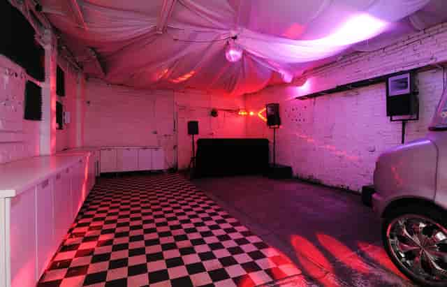 Versatile event space with checkered floor, ideal for gatherings and presentations.