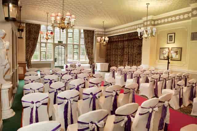 Elegant Terrace Room at Best Western for weddings, featuring purple sashes and natural light.
