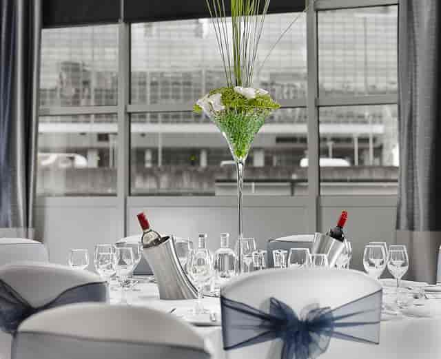 Elegant dining table with floral centerpiece at The National, DoubleTree Victoria event.