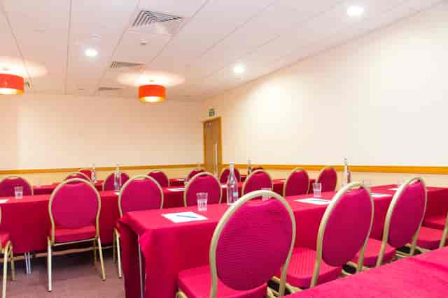 William Preston in a red-themed classroom for training workshops and corporate events.