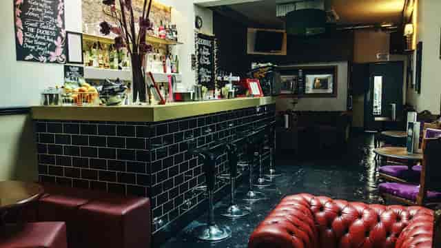 Stylish bar venue with cozy seating, perfect for cocktail receptions and networking events.