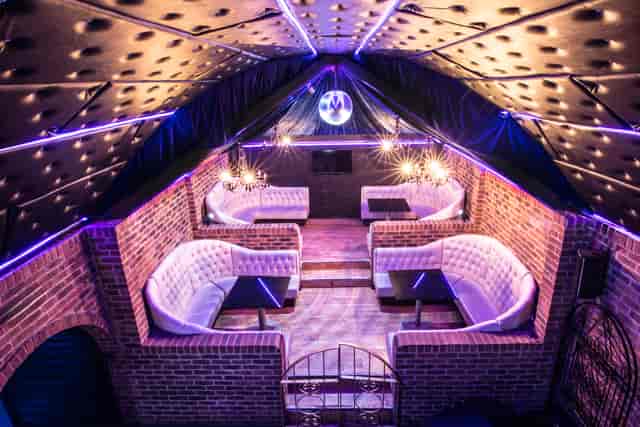 Stylish event space with plush seating and disco ball, perfect for parties and networking.