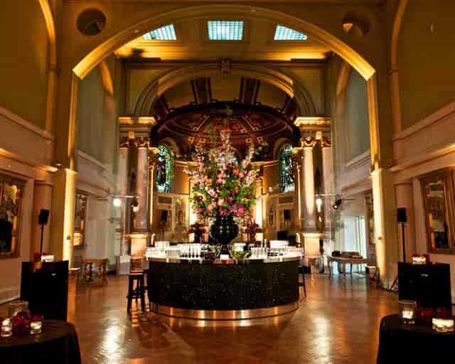 Soane Hall event space with high ceilings and floral bar arrangement for elegant gatherings.
