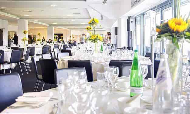 Elegant 1882 Suite at Edgbaston Stadium, set for formal networking events with sunflowers.