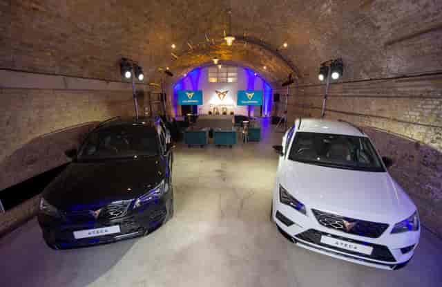 Stylish event space with sleek cars, perfect for automotive product launches.