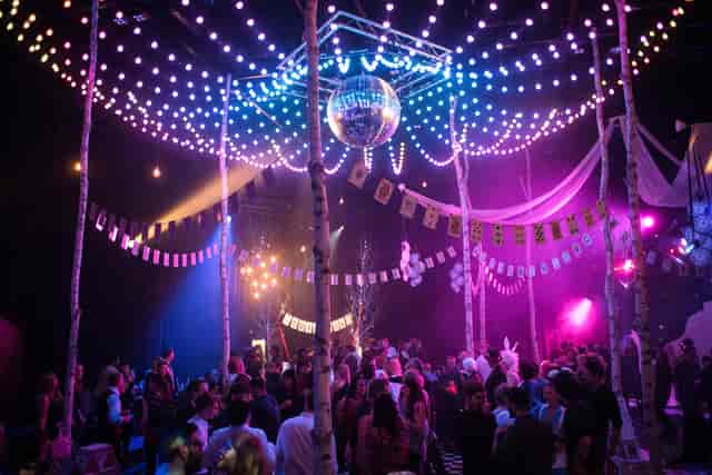Vibrant event space at The Studio Theatre with colorful lights for networking and celebration.