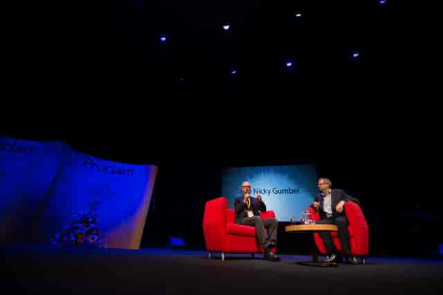 Panel discussion stage setup with red chairs at The House, Birmingham REP venue.