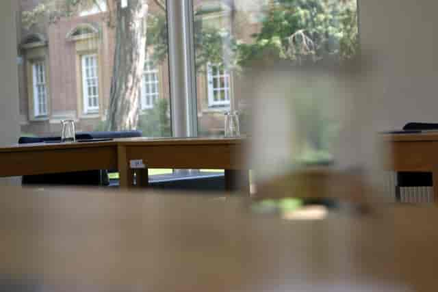 Maplethorpe Seminar Room at St Hugh's College, ideal for workshops with wooden tables.