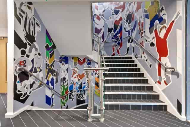 Vibrant athlete mural at Players Lounge, Hotel Football - perfect for events and networking.