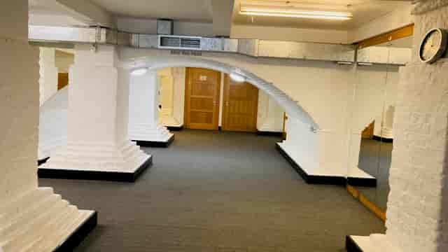 Versatile event space in St John's Hoxton with arched pillars, ideal for gatherings.