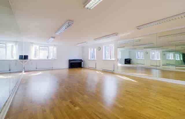Versatile event space with polished wooden floor, ideal for workshops and dance classes.
