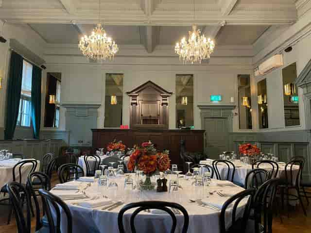 Elegant event space at Spey Bar, featuring floral centerpieces and a stage for celebrations.