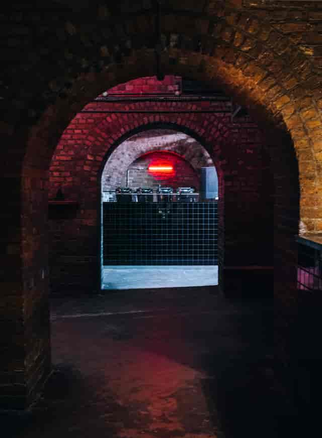 Stylish venue with exposed brick arches, perfect for networking events and gatherings.