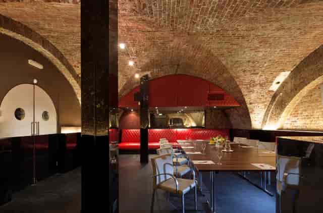 Modern event space with exposed brick arches, ideal for corporate events and private dinners.