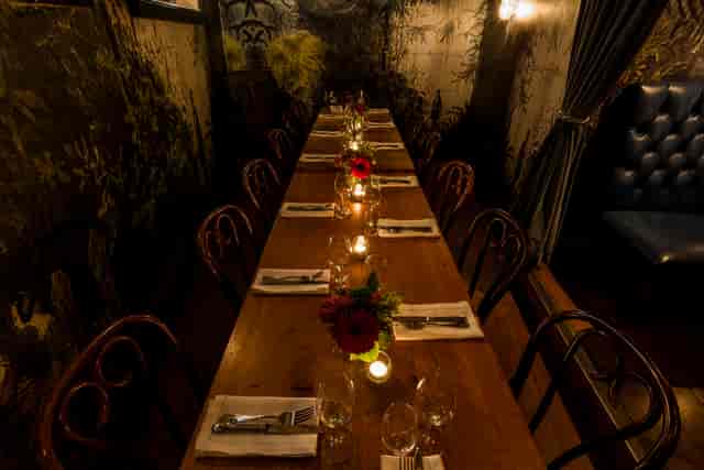 Elegant private dining table with floral centerpieces for intimate gatherings and corporate events.