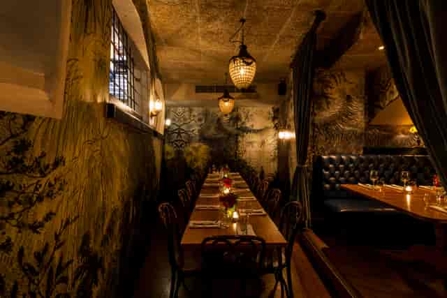 Private dining space with wooden table, ideal for intimate events and gatherings.