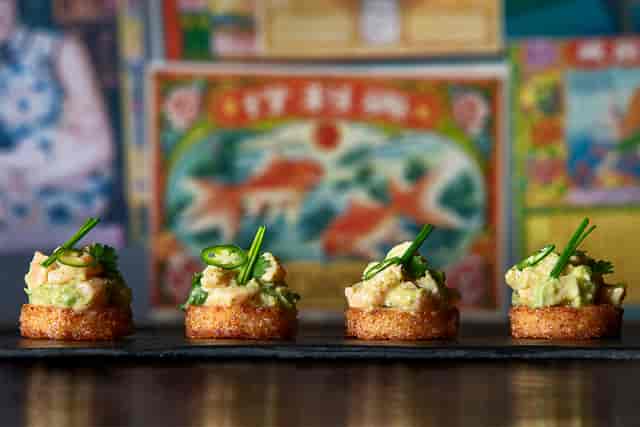 Upscale appetizer platter with gourmet bites at Yuu Kitchen, perfect for cocktail receptions.