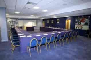 Rowley Suite at King Power Stadium, elegant purple meeting room for corporate events.