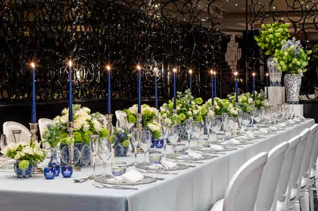 Elegant banquet table with blue and white decor for formal dinners or corporate events.