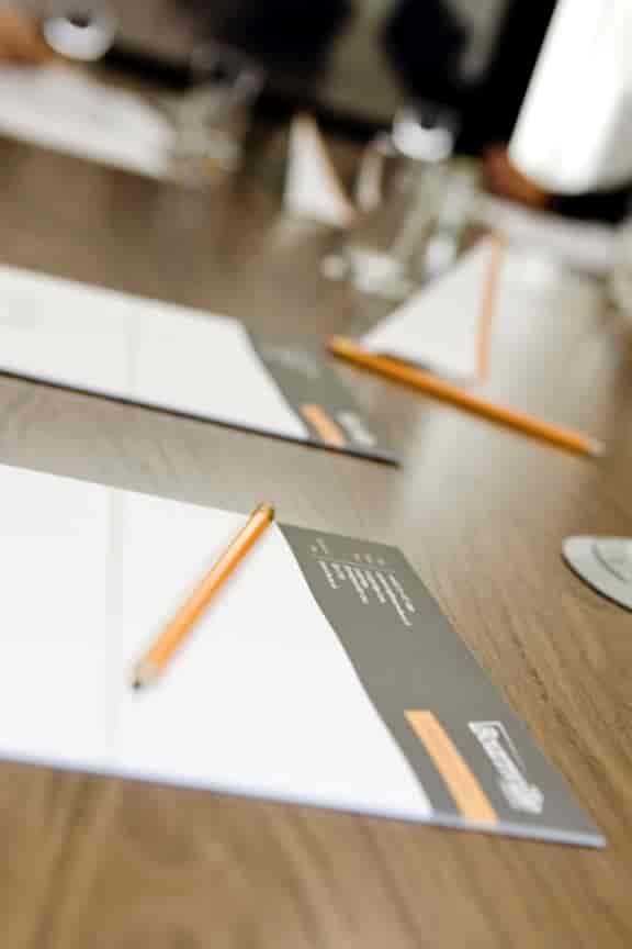 Cofton Suite meeting setup with polished table, notepads for professional events.