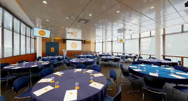Council Chamber in Congress Centre with round tables, ideal for corporate meetings and conferences.
