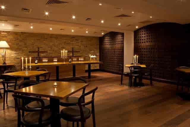 Elegant Josephine Room with warm wooden tables, perfect for corporate meetings and intimate gatherings.